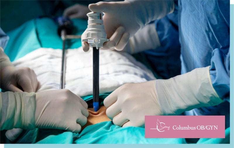 A surgeon and their team are performing minimally invasive surgery on a patient using small incisions and specialized instruments.