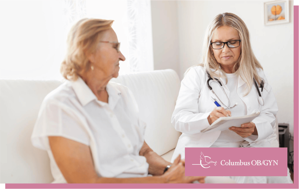 An elderly woman consulting a doctor about menopausal symptoms in a medical office.